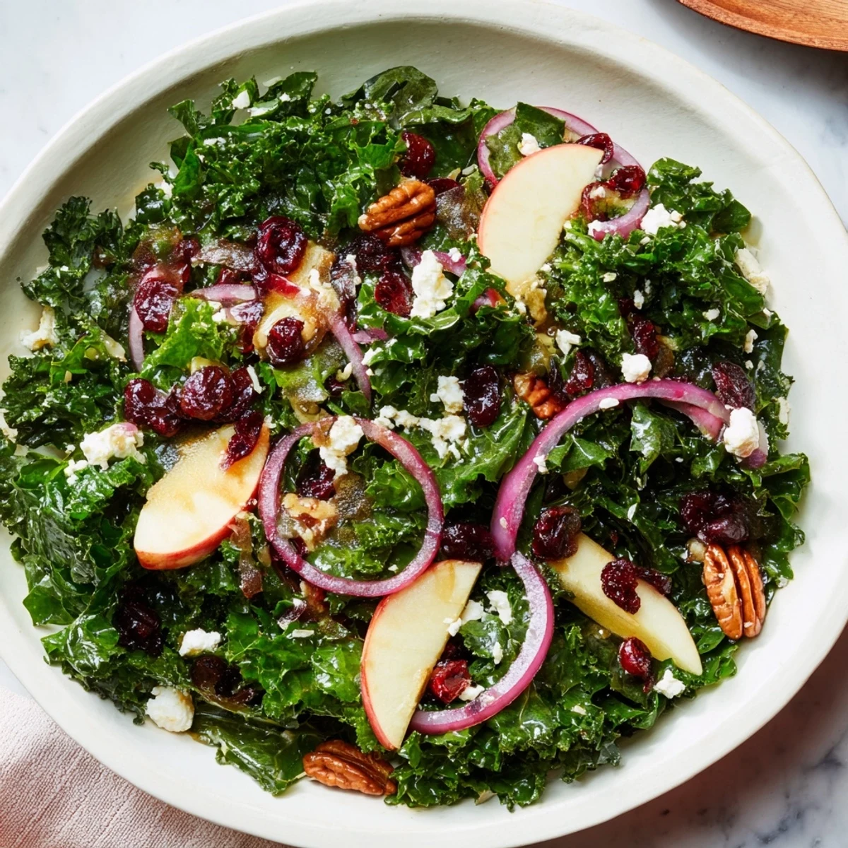 Vibrant Winter Kale Salad with pecans and cranberries, showing sweet cranberries and toasted pecans.