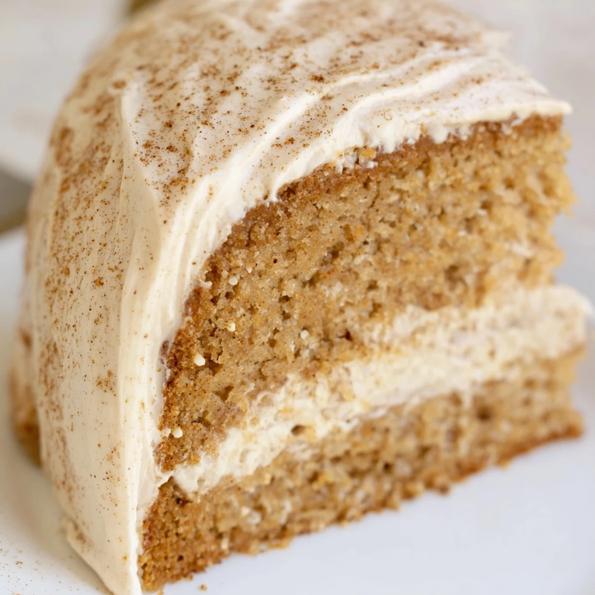 A slice of Spiced Chai Latte Cake showing tender crumb and sweet spice swirls.