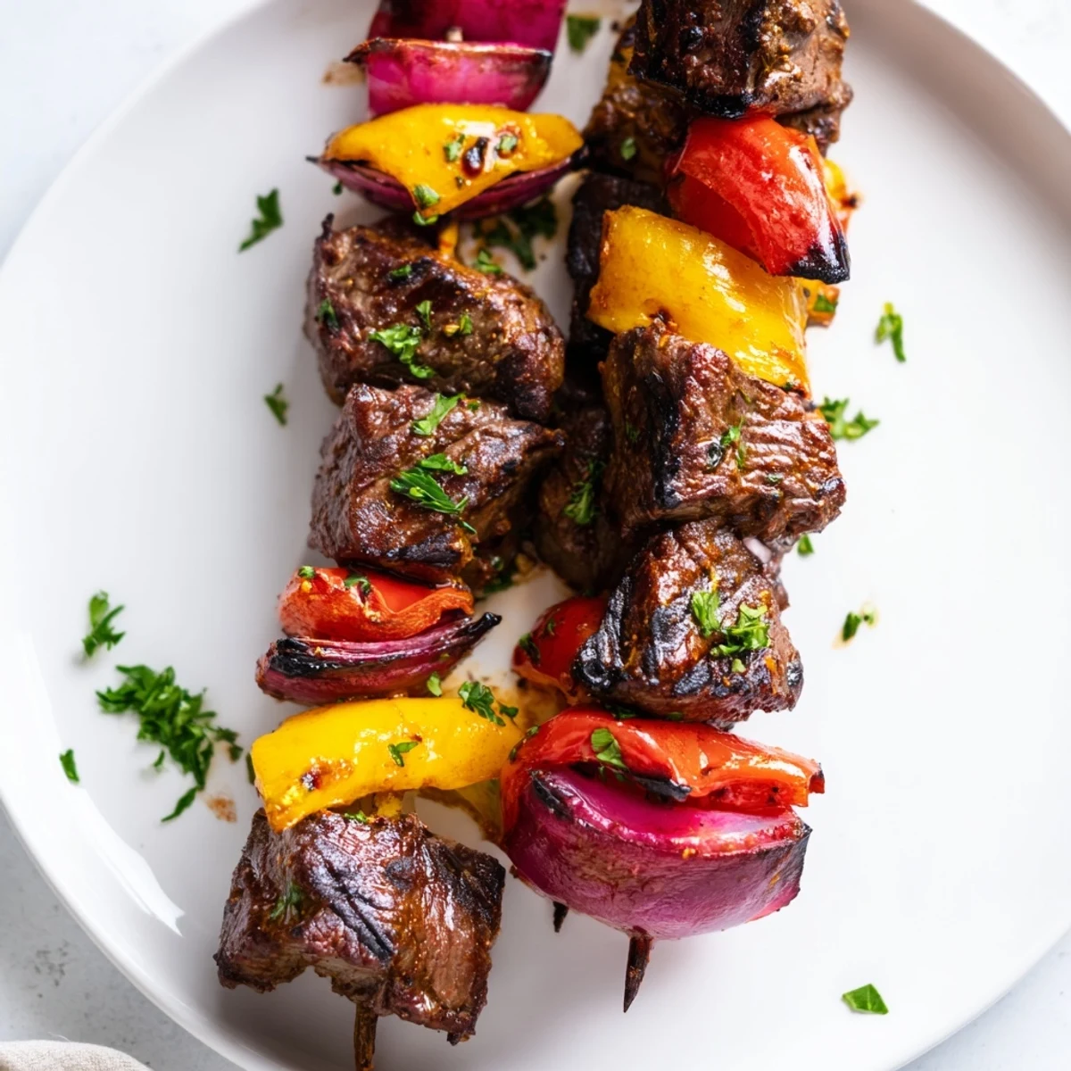 Tender beef skewers with colorful veggies and fresh parsley on a wooden serving platter.
