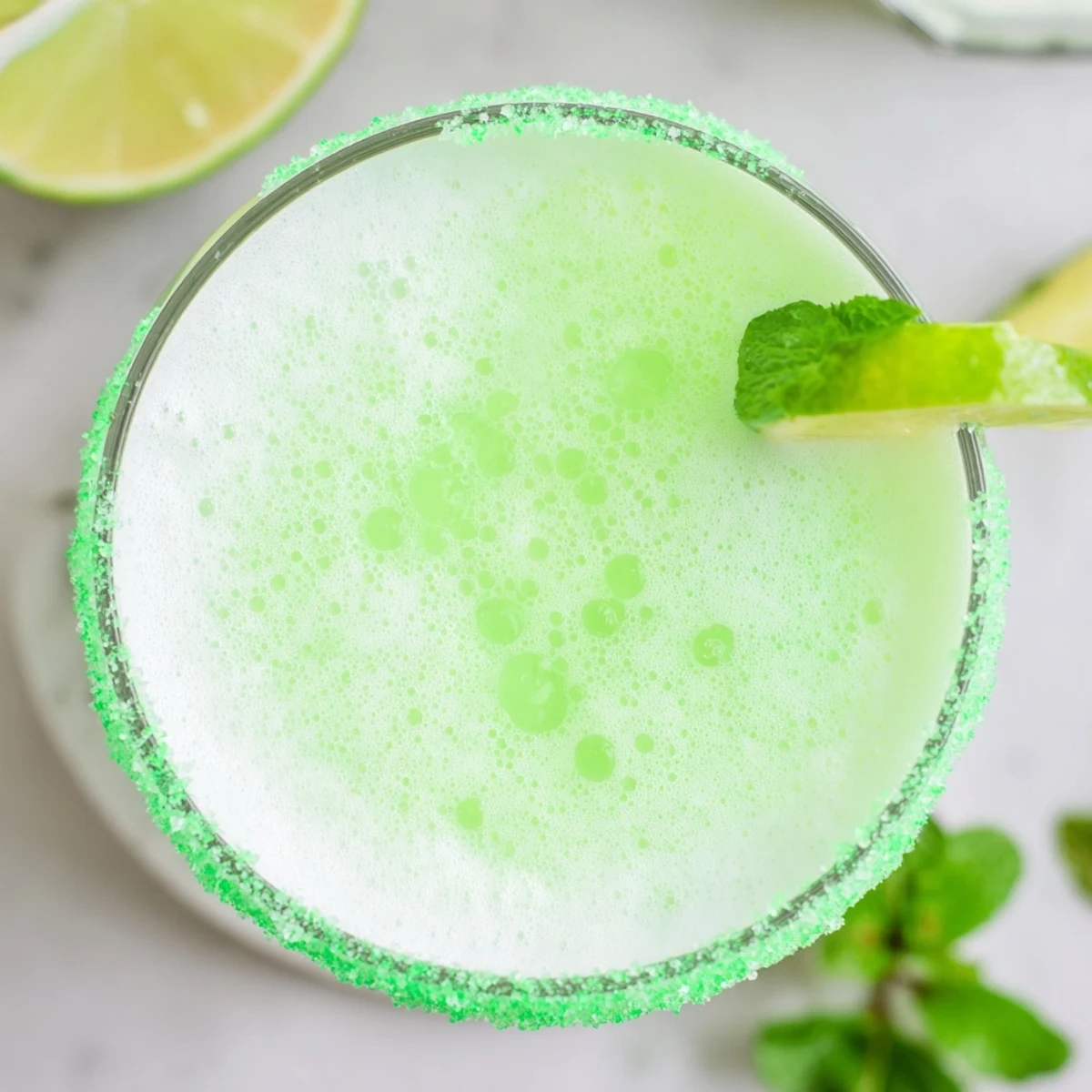 Pouring the Leprechaun Lime Sherbet Punch reveals its bubbly texture and creamy melting sherbet, ready for a St. Patrick's Day party.