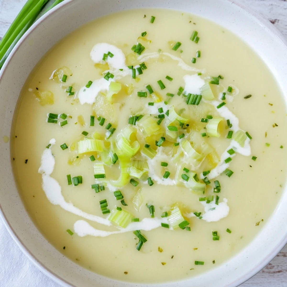 Golden-brown Leek and Potato Soup simmering in a pot, featuring tender potatoes and leeks in a velvety cream broth.