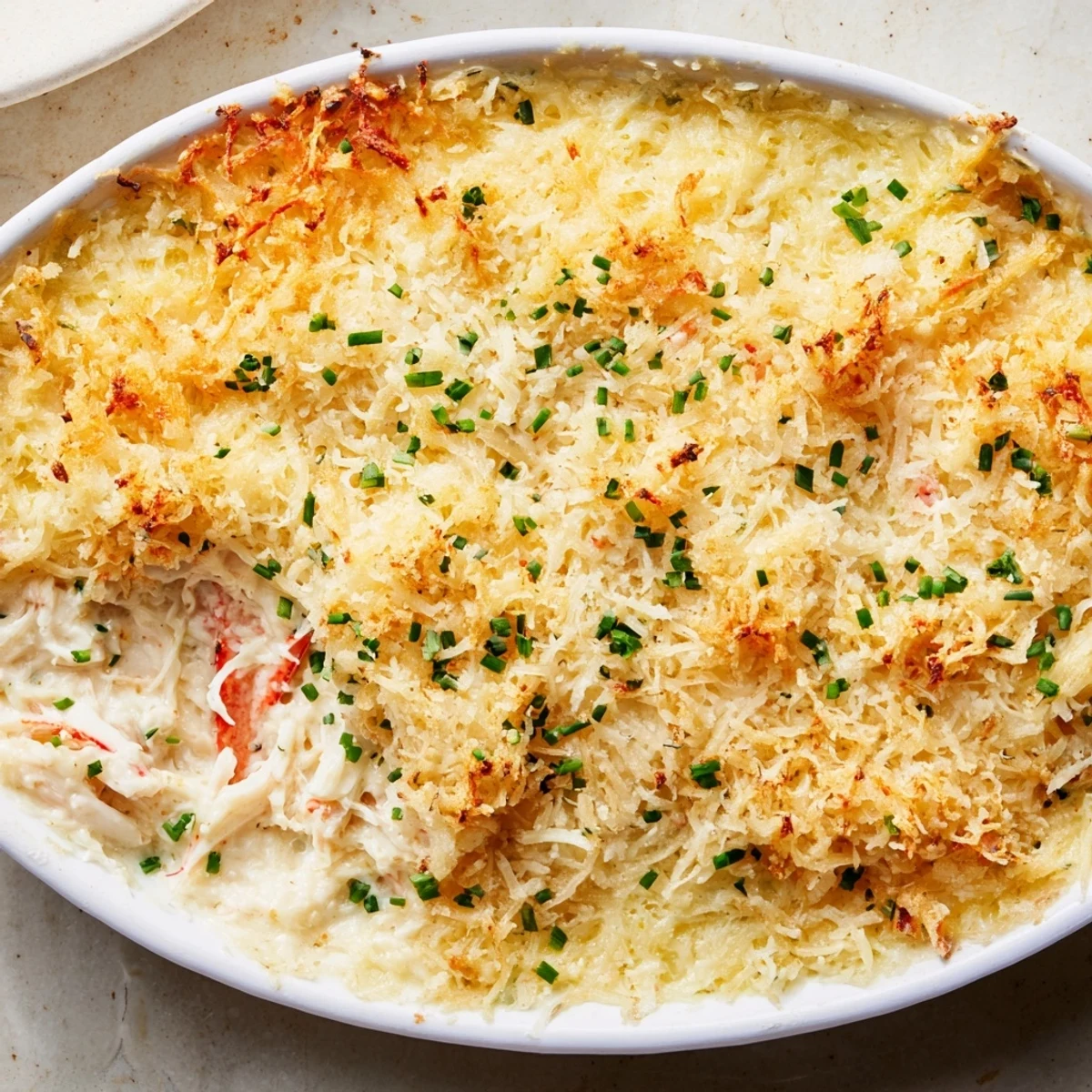 A baked Crab Dip with Crackers and Crostini, featuring tender crab meat and a cheesy, golden topping.