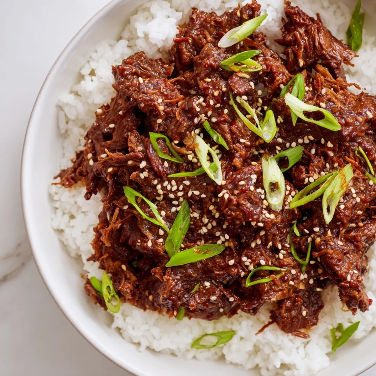 Slow Cooker Korean Beef served in crisp lettuce wraps with a drizzle of savory-sweet sauce and a sprinkle of sesame seeds.