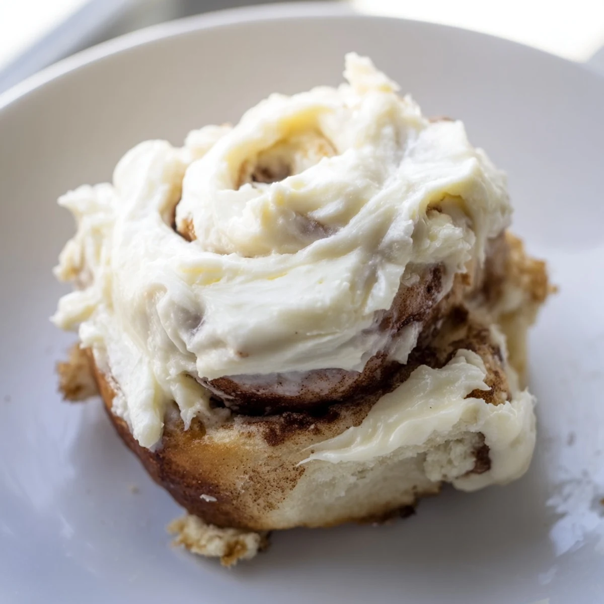 Freshly baked Keto Cinnamon Buns drizzled with icing, perfect for a low-carb snack.