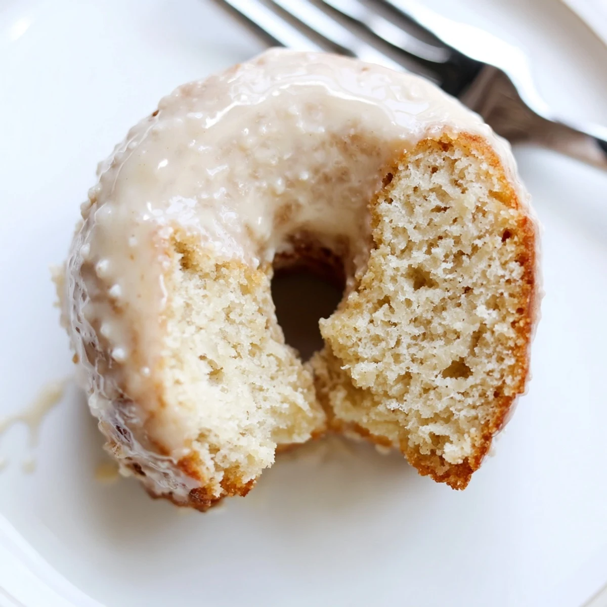 Freshly baked Baked Banana Bread Donuts with a moist crumb and warm cinnamon aroma on a wire rack.