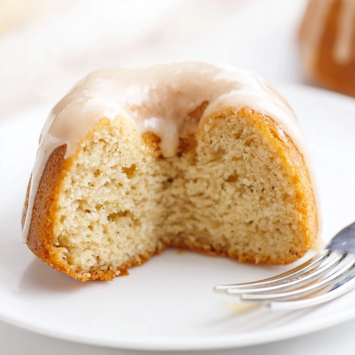 Glazed Baked Banana Bread Donuts glistening with a sweet vanilla drizzle, ready for a cozy breakfast treat.