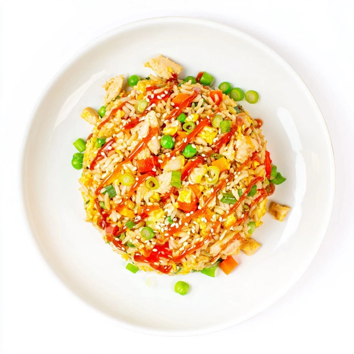 Golden Bang Bang Fried Rice is served in a skillet, garnished with green onions and sesame seeds.