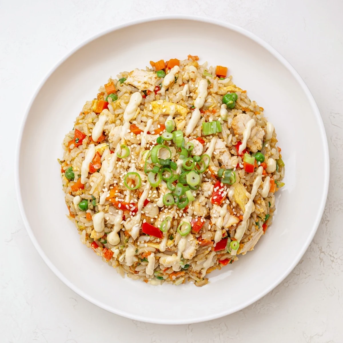 Close-up of Bang Bang Fried Rice highlighting vibrant carrots, bell peppers, and a spicy, tangy sauce.