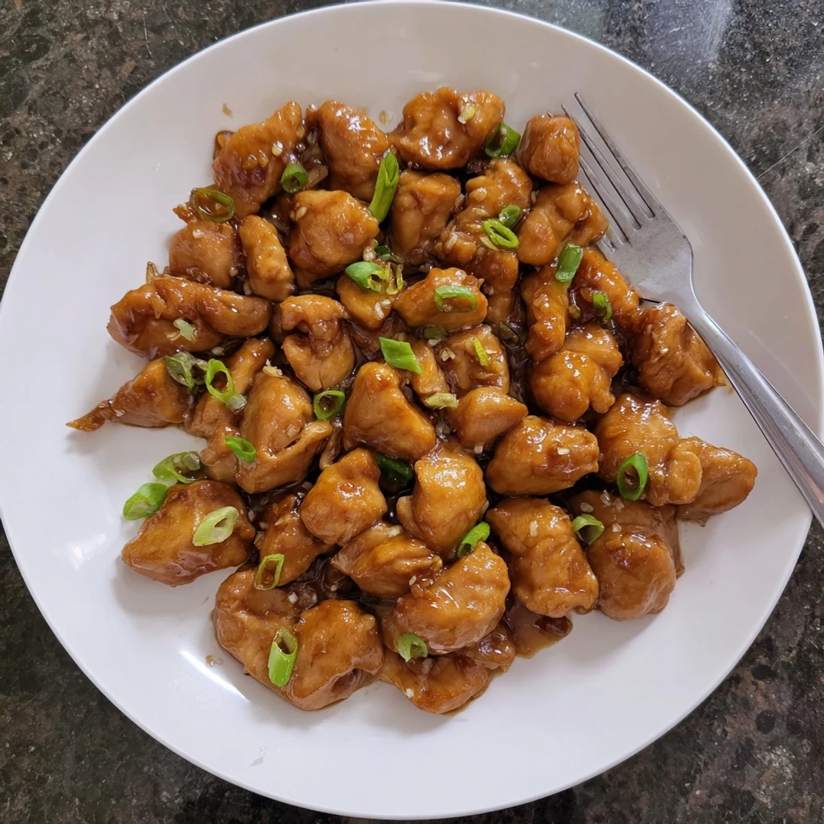 Savory Mongolian chicken simmered with garlic ginger in a rich dark glossy sauce