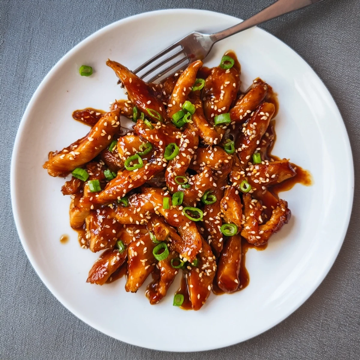 Savory Asian-style sesame chicken slow-cooked to perfection in rich sweet and tangy sauce