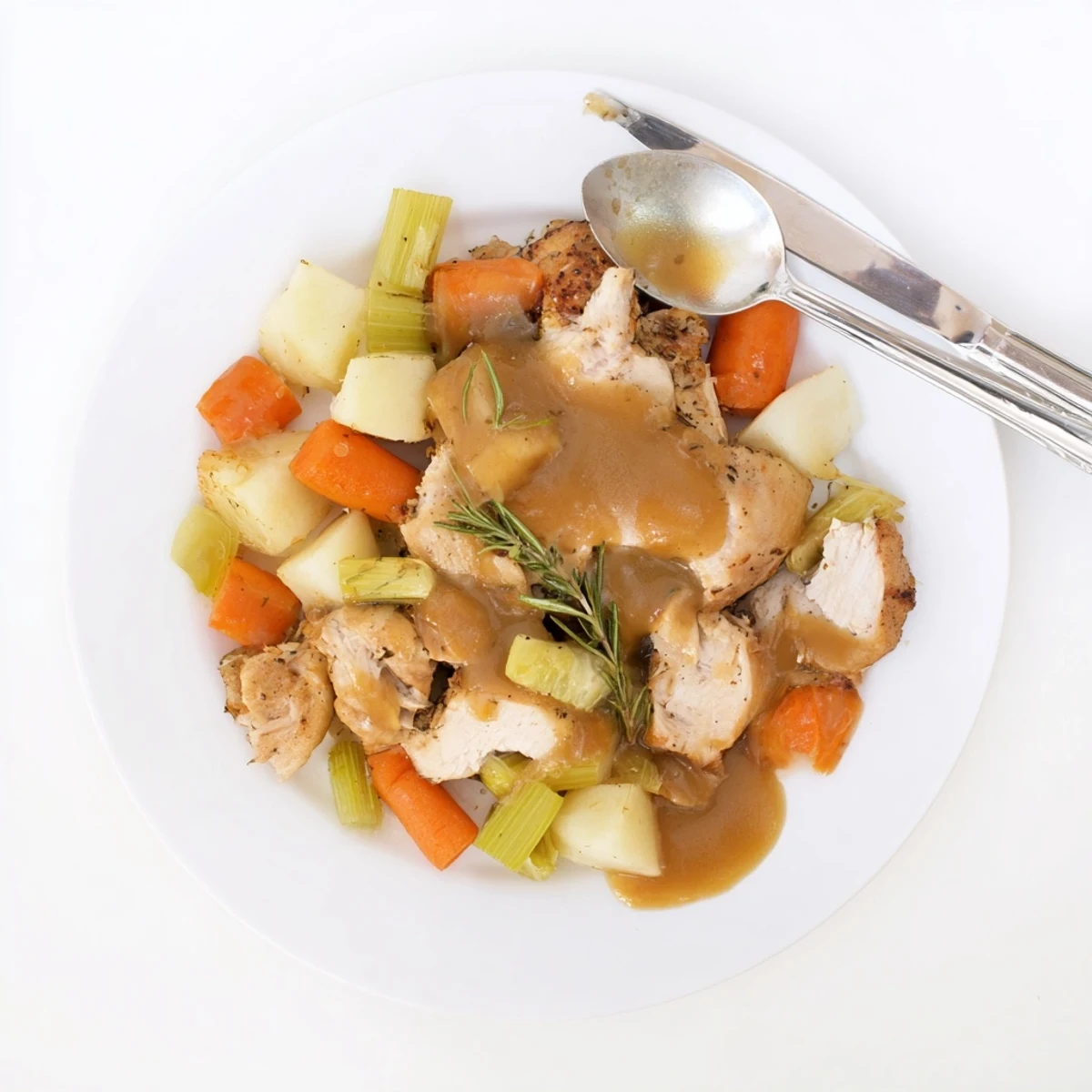 Moist comfort food crockpot chicken pot roast featuring whole bird with root vegetables in a deep savory broth