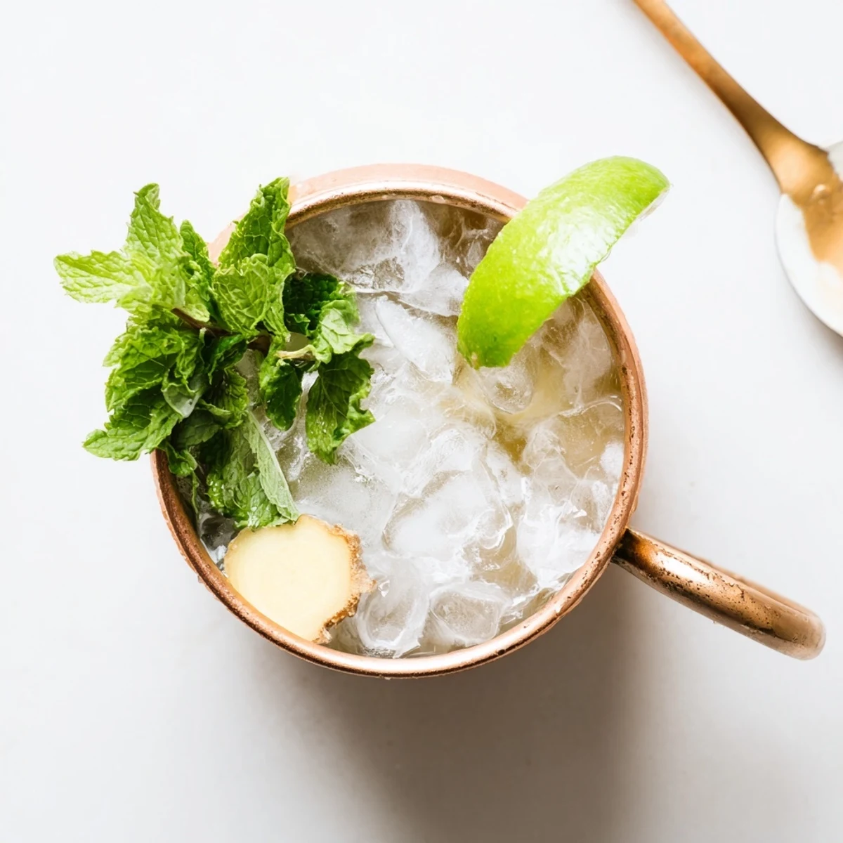 Refreshing non-alcoholic virgin Moscow Mule mocktail with ginger beer, lime juice, and floating mint leaves