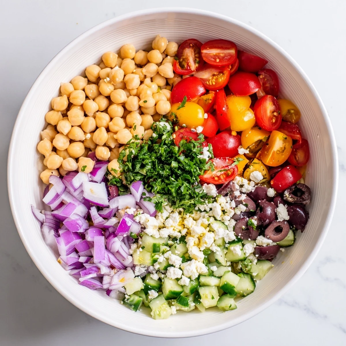 Colorful Mediterranean chickpea salad bowl with crisp vegetables and tangy lemon dressing