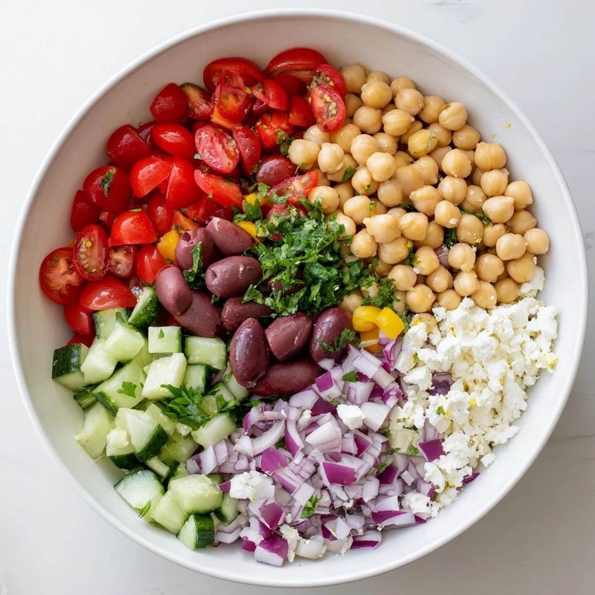 Protein-packed Mediterranean chickpea salad tossed in zesty olive oil and herbs, served chilled
