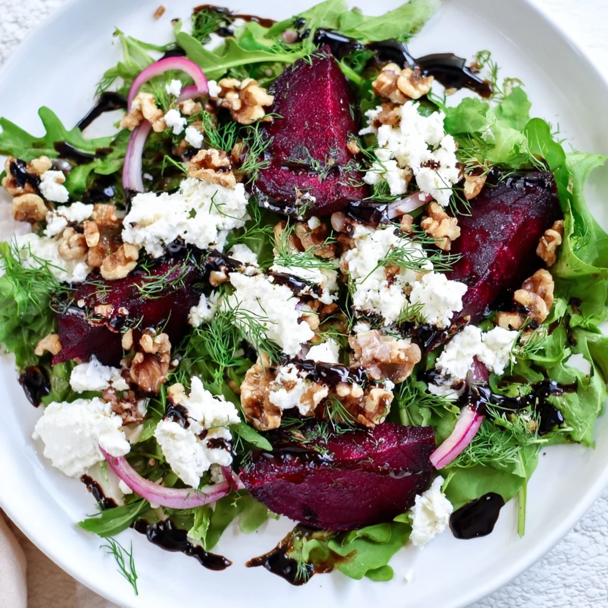Golden roasted beet wedges tossed with mixed greens, crumbled goat cheese, and toasted walnuts