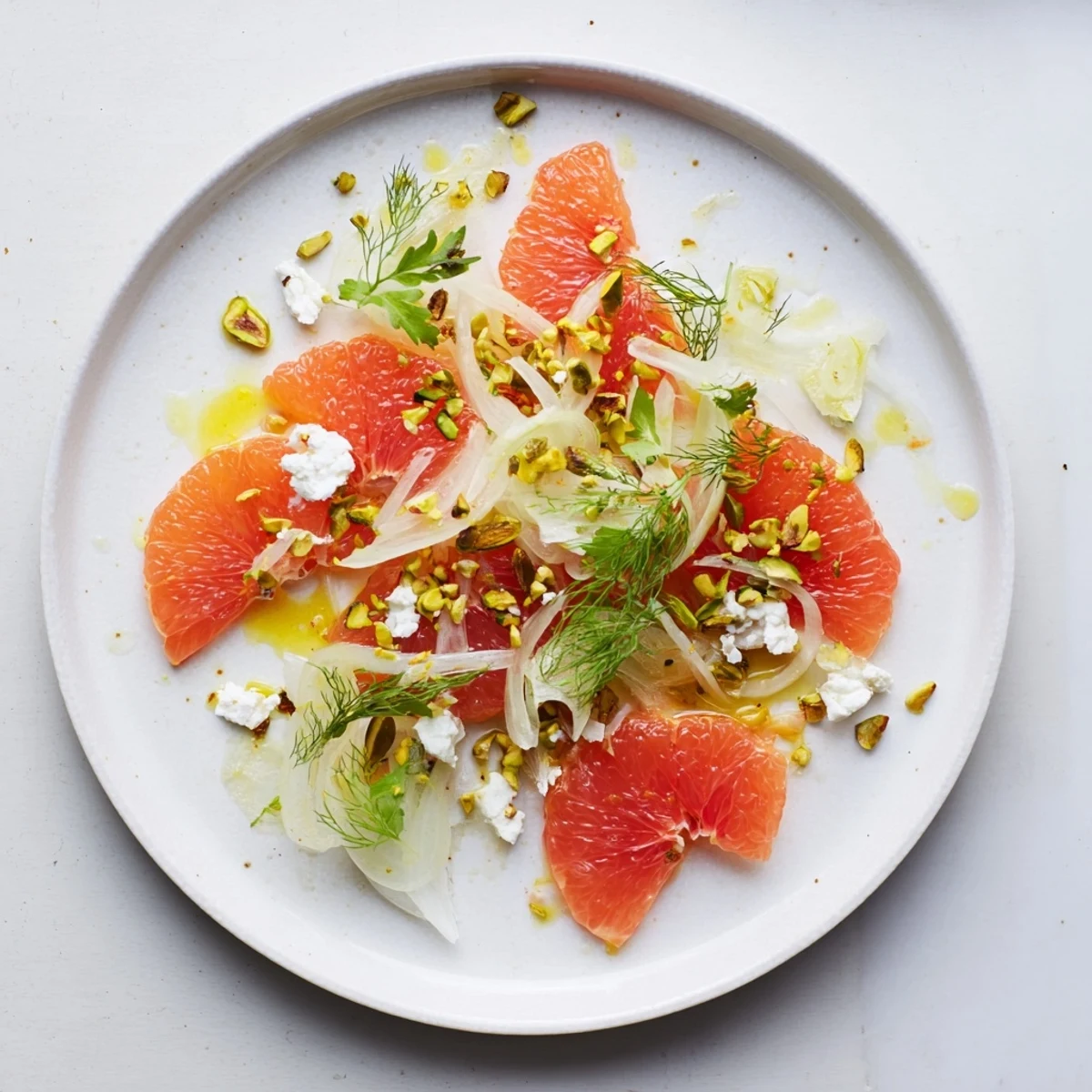 Fresh Grapefruit, Goat Cheese & Fennel Salad with juicy citrus segments and crumbled cheese atop peppery arugula