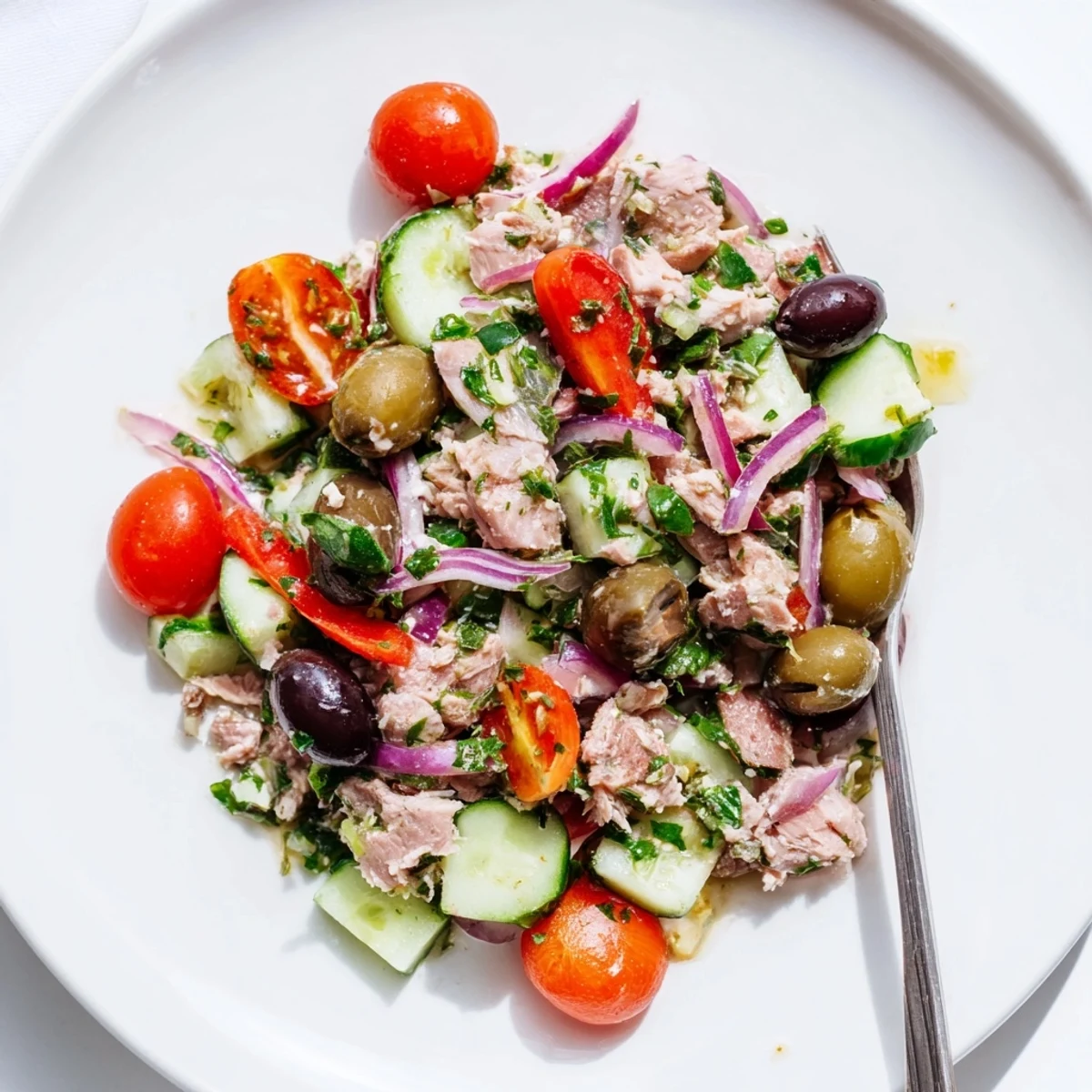 Healthy Mediterranean tuna salad featuring roasted peppers, fresh herbs, and bright lemon vinaigrette