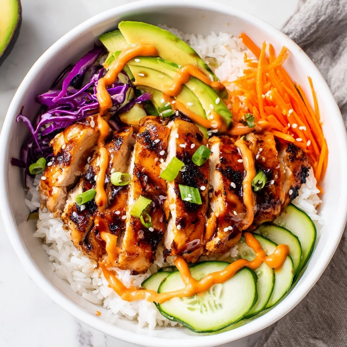 Vibrant meal prep bowl showcasing sweet and savory Korean BBQ chicken with crisp veggies, sesame seeds, and spicy mayonnaise topping
