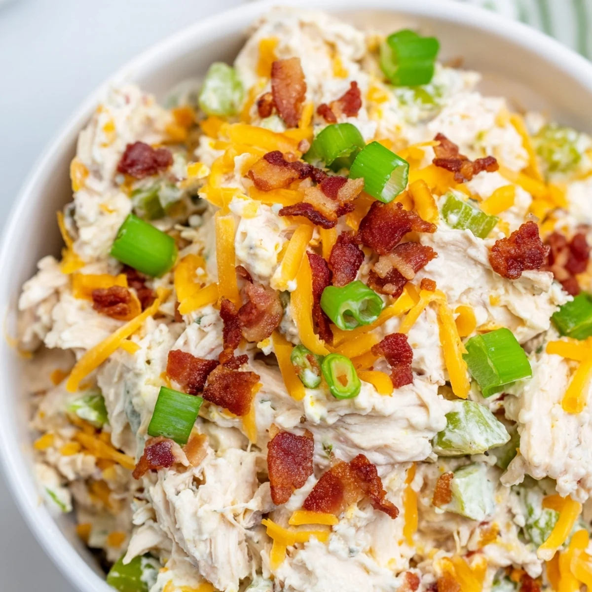 Creamy jalapeno popper keto chicken salad loaded with bacon bits, cheddar cheese, and fresh green onions
