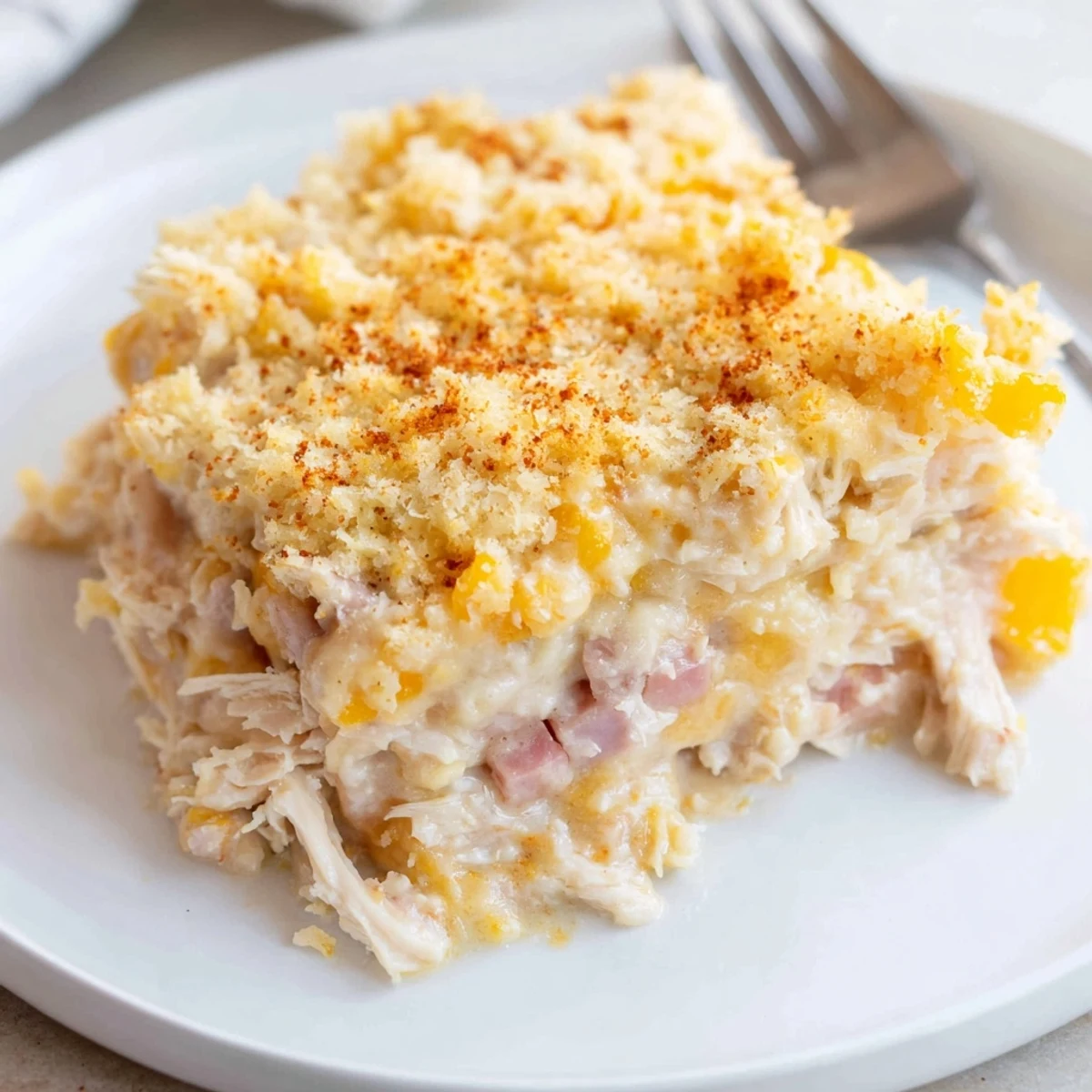 Golden, bubbling Chicken Cordon Bleu Casserole Recipe with crisp Parmesan-Panko topping, steaming
