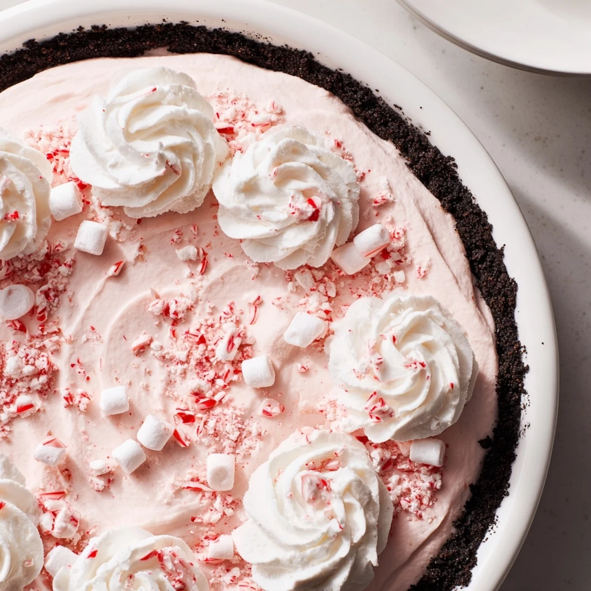 Candy Cane Pie with creamy peppermint filling and chocolate cookie crust, chilled