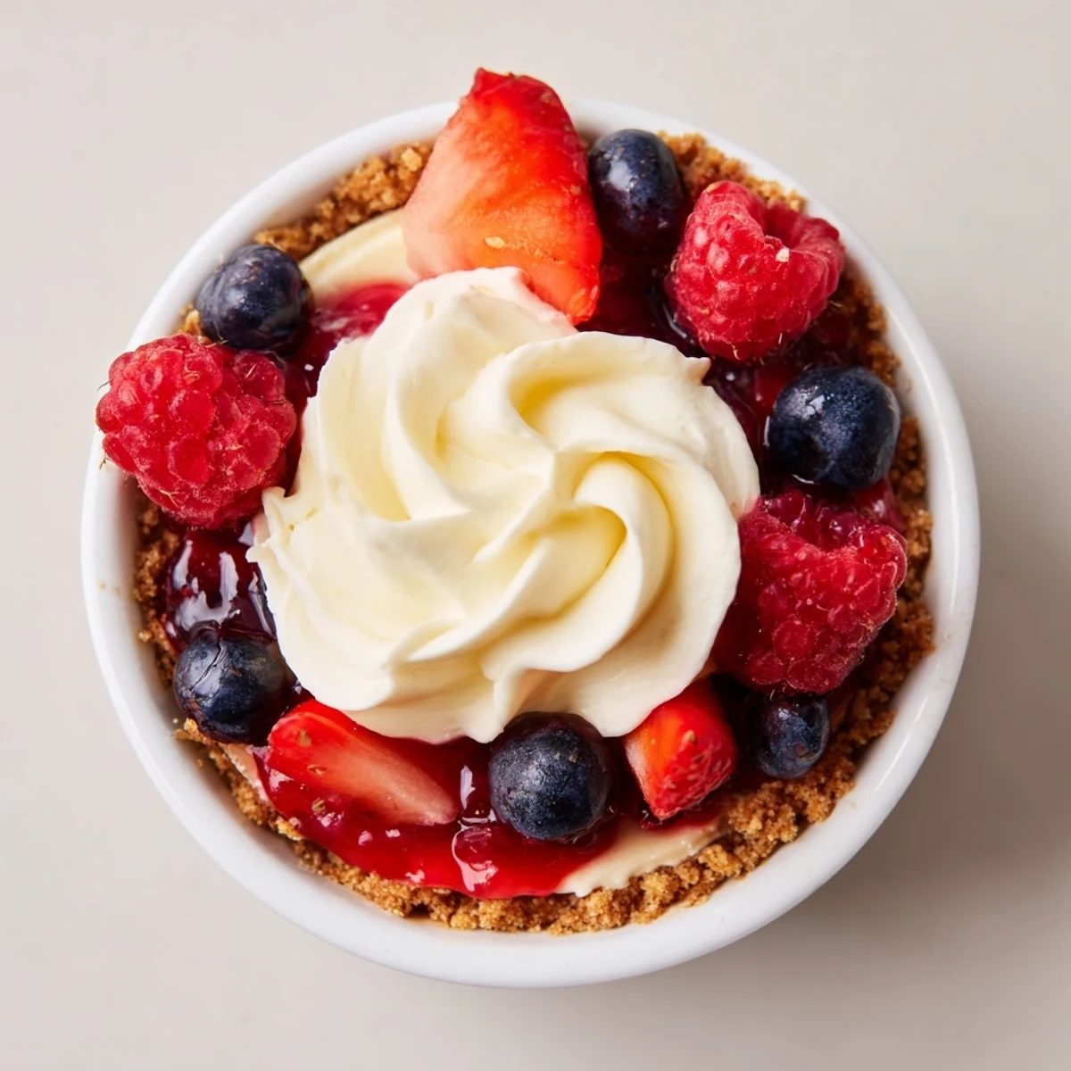 Individual Berry No Bake Cheesecakes served cold, creamy filling and crunchy crust