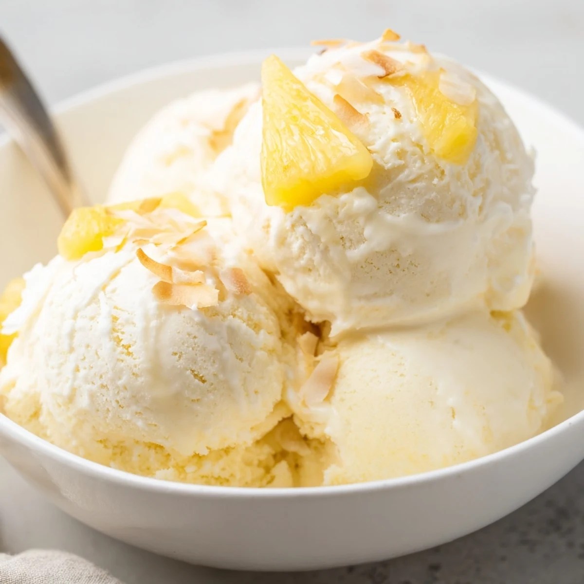 Creamy Pineapple Ice Cream scoops glistening, tropical aroma, perfect for summer