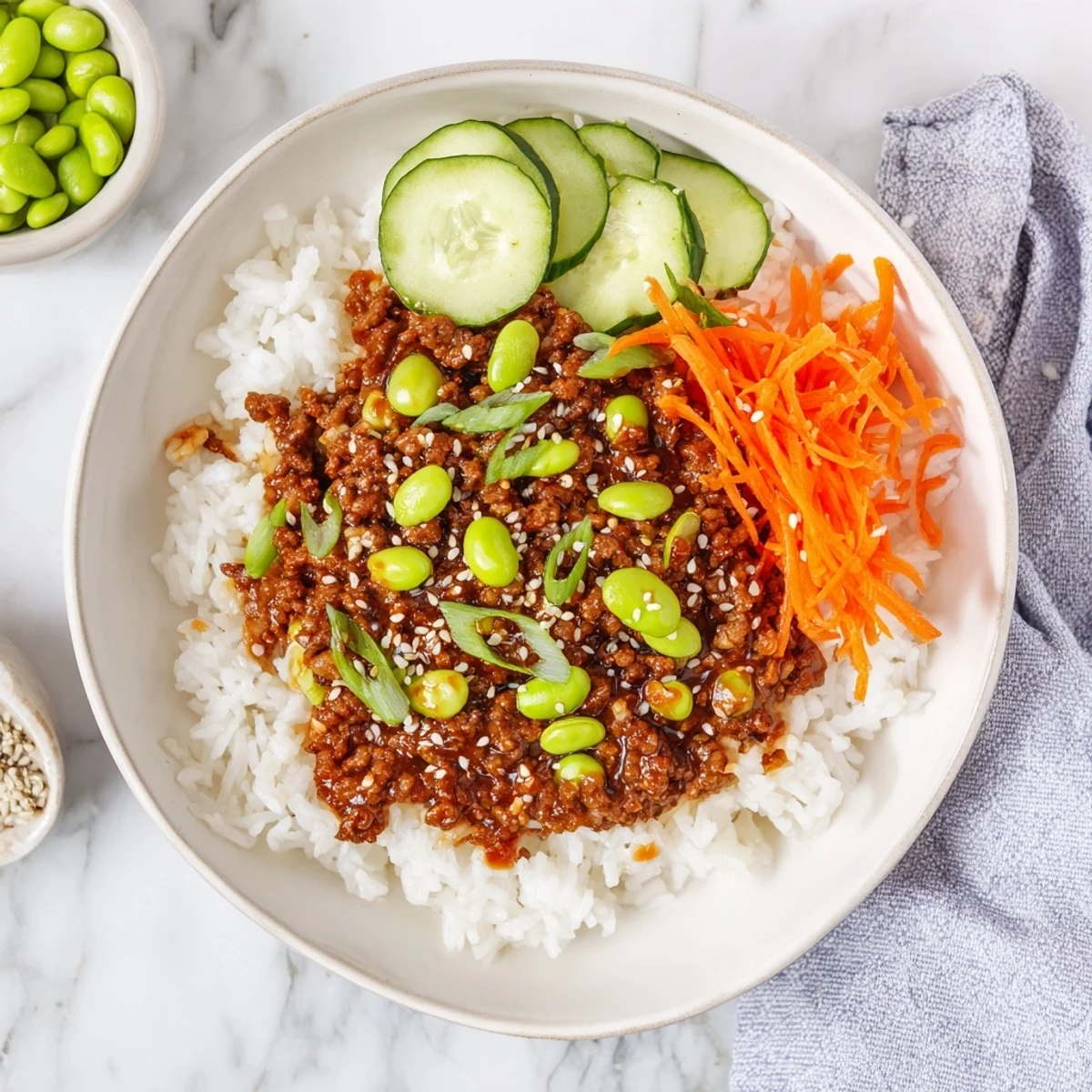 Glossy ground beef glazed in spicy hot honey served over fluffy white rice with colorful vegetables