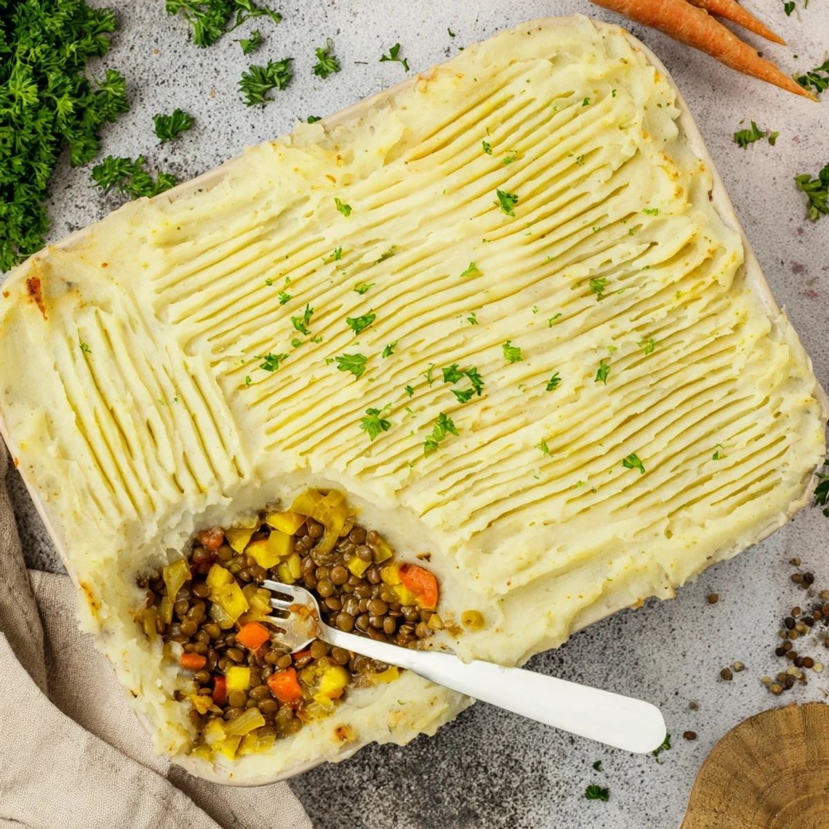 Golden-topped vegan French onion shepherd's pie with fluffy mashed potato ridges