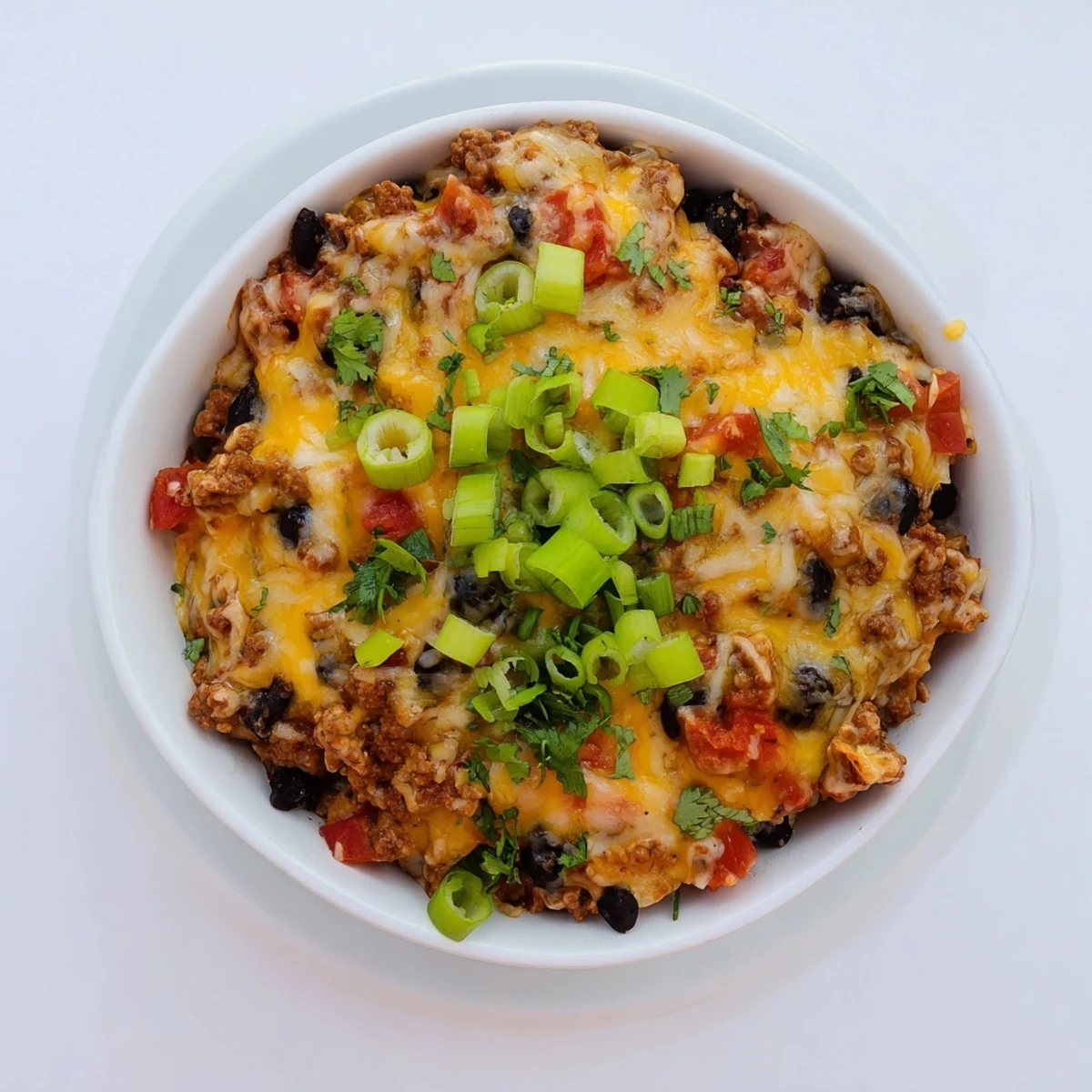 Gaming day spread featuring cheesy Super Nachos Dip garnished with fresh cilantro, green onions, and crispy tortilla chips