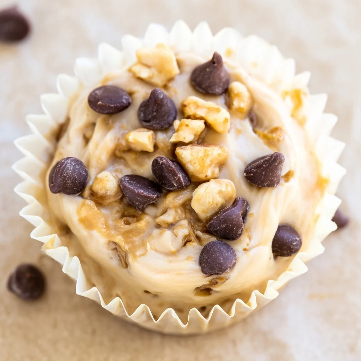 Creamy frozen peanut butter Greek yogurt bites topped with chopped peanuts on a white plate