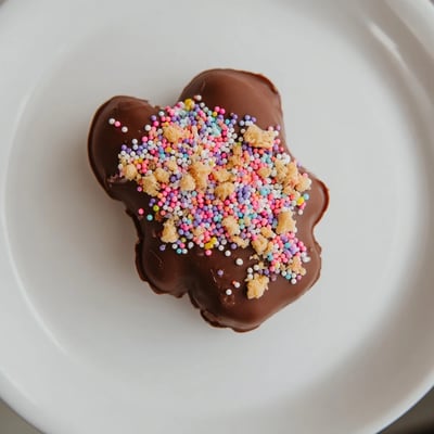 A close-up view of Chocolate Covered Peeps dipped in melted chocolate, ready for a sweet Easter celebration.
