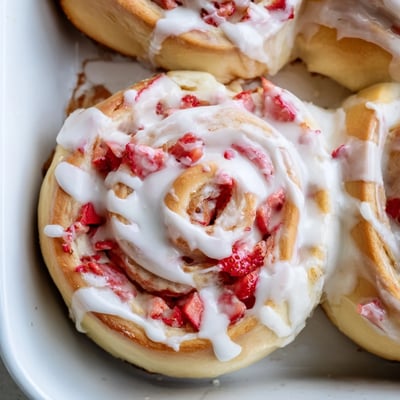 Soft baked strawberry cheesecake rolls swirled with cream cheese and fresh berries